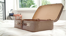 Open, neatly packed suitcase on bed